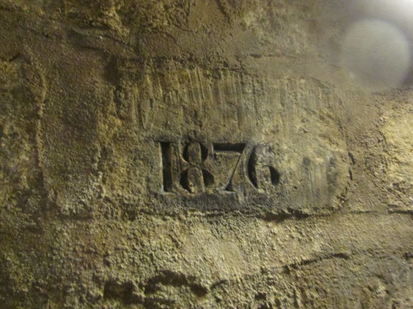 1876 stamped in a brick: , Catacombs of Paris officially opened to the public.