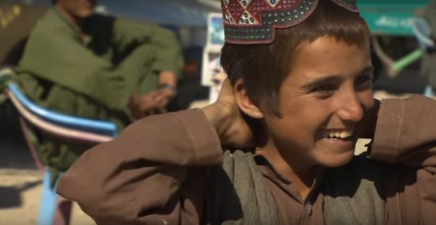 Taliban History Afghanistan book, Rafik, an Afghan boy laughing