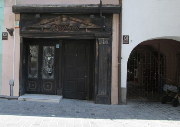 The old shop window that inspired the printing press of Kronstadt, Brasov, in "When Secrets Bloom": "The old wooden building, with its weathered planks, stood stoically against any weather."
