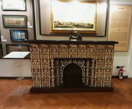 Map Museum ceramic and wood-trimmed fireplace